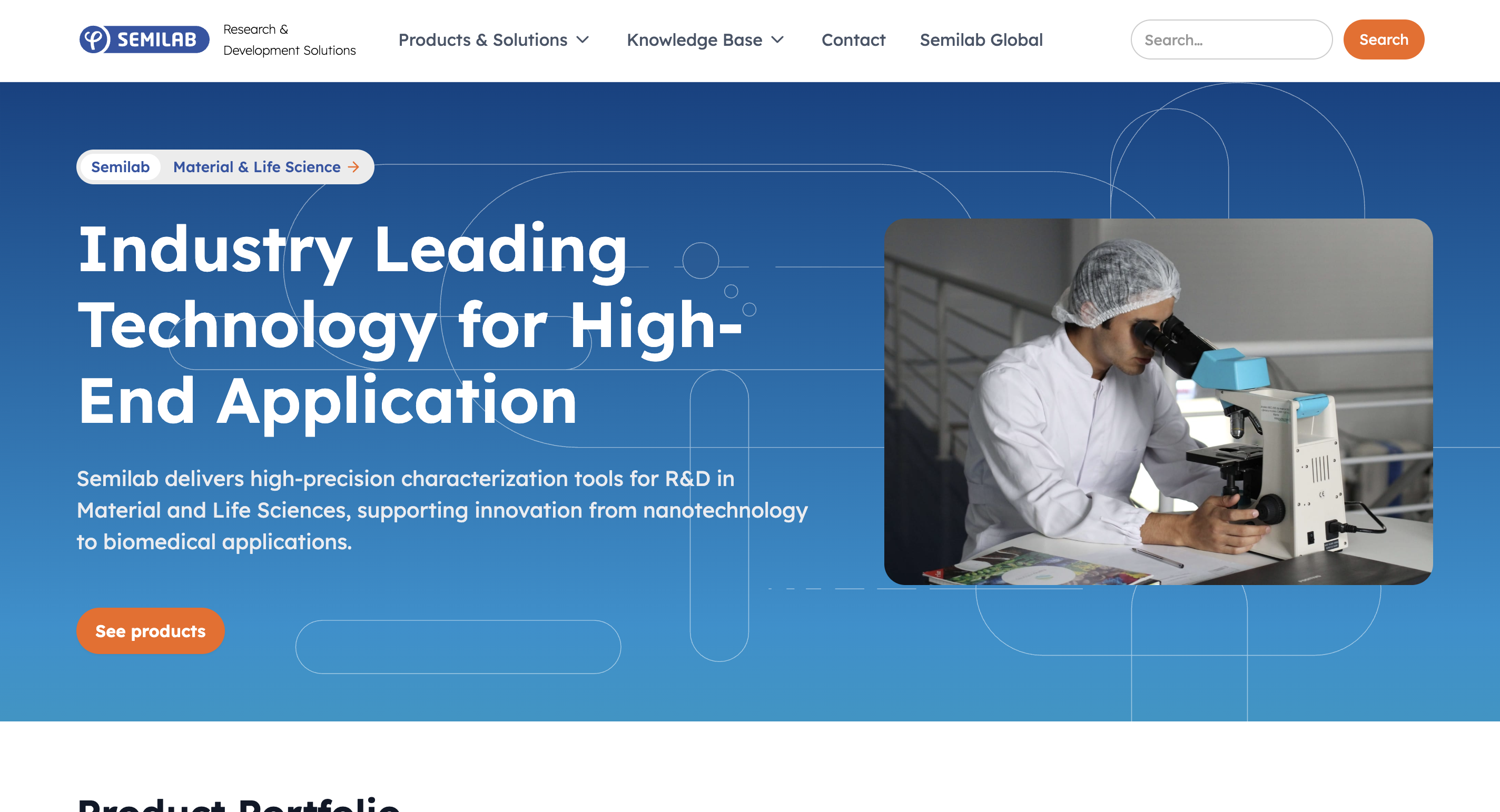 Scientist in lab coat and hairnet looking into a microscope in a laboratory setting.